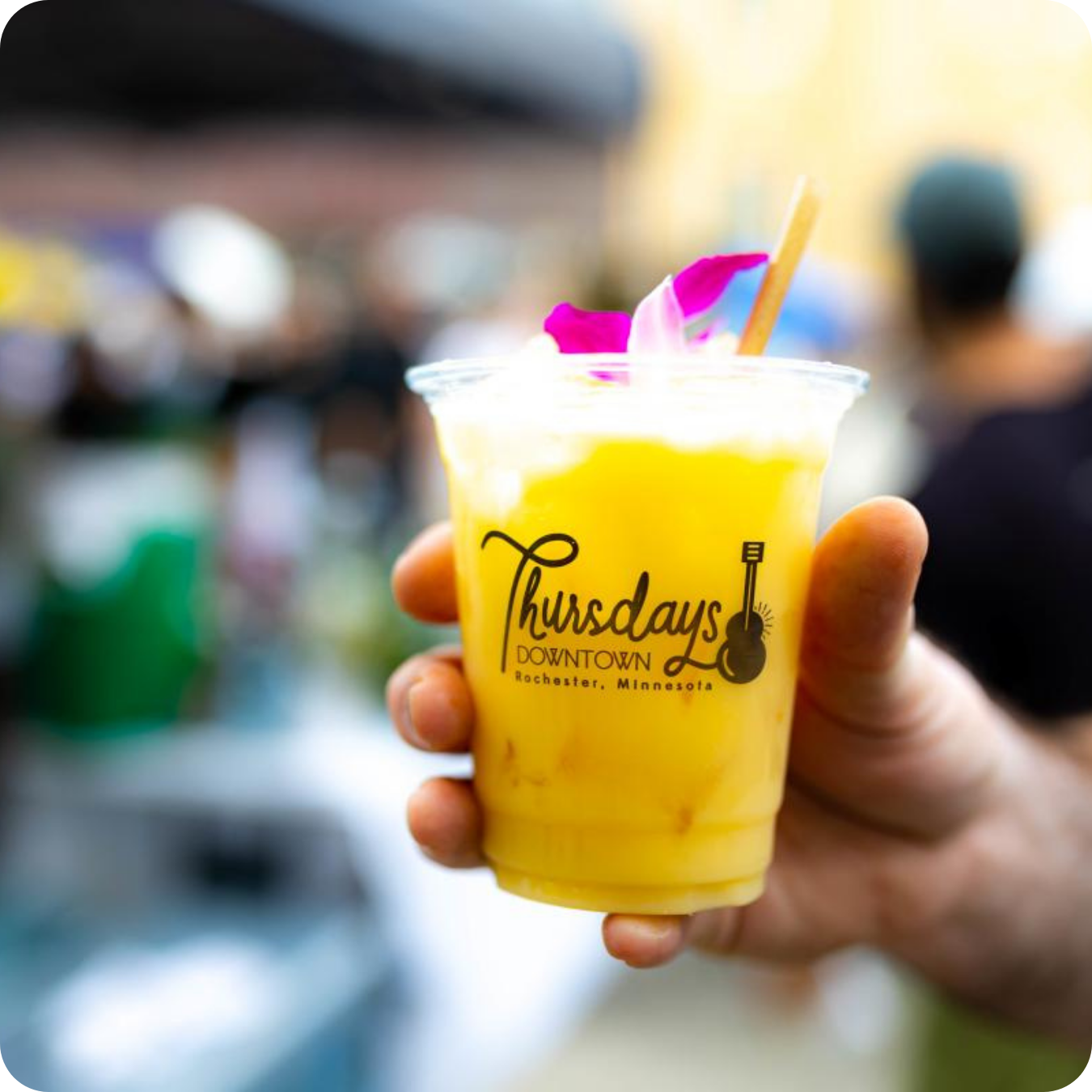 A photo of a frozen beverage in someones hand. The cup says 